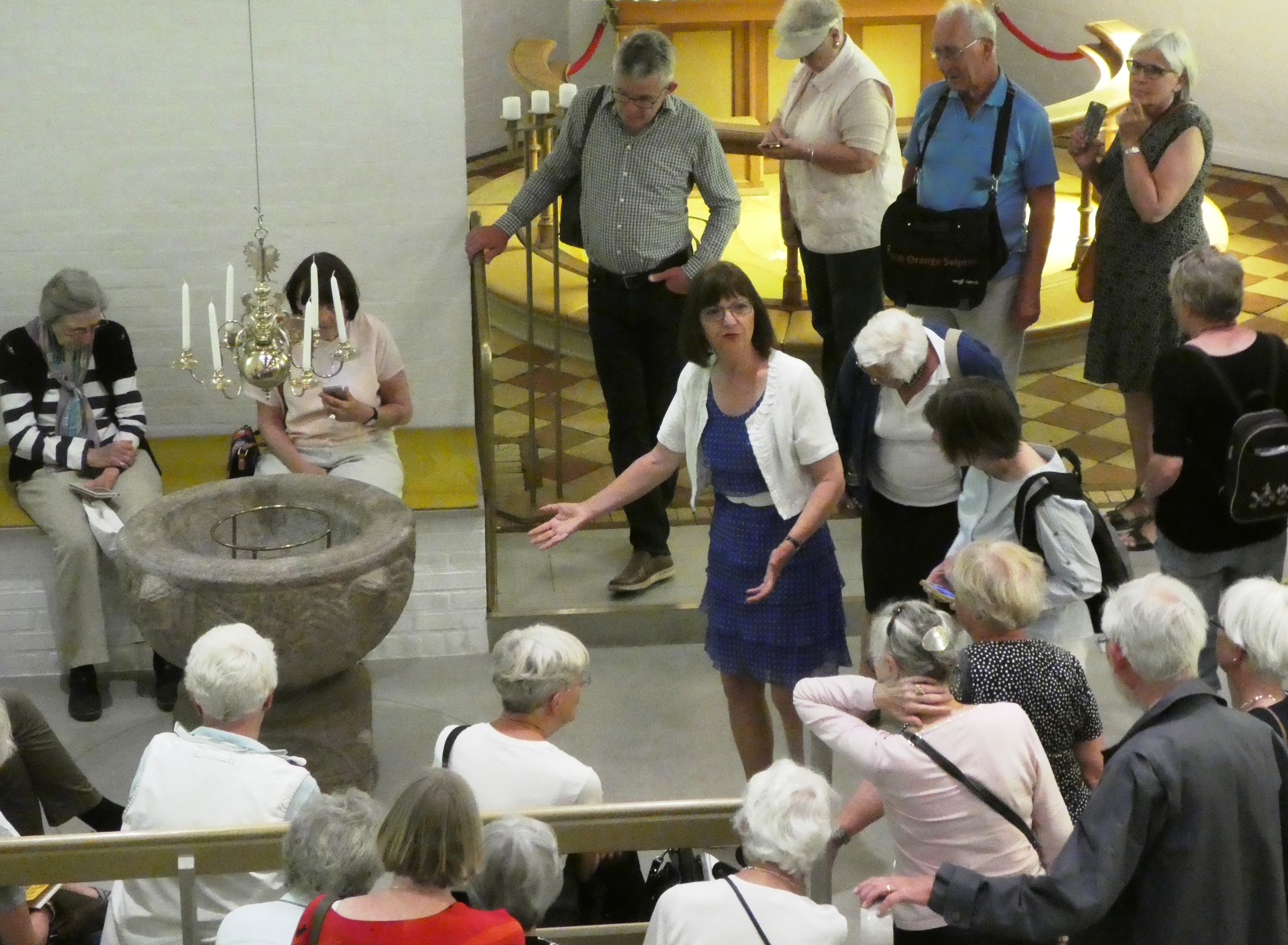 BB viser løvefonte på kirkeekskursion maj 2018 med gruppe fra Nivå, her Galten Kirke P1080387